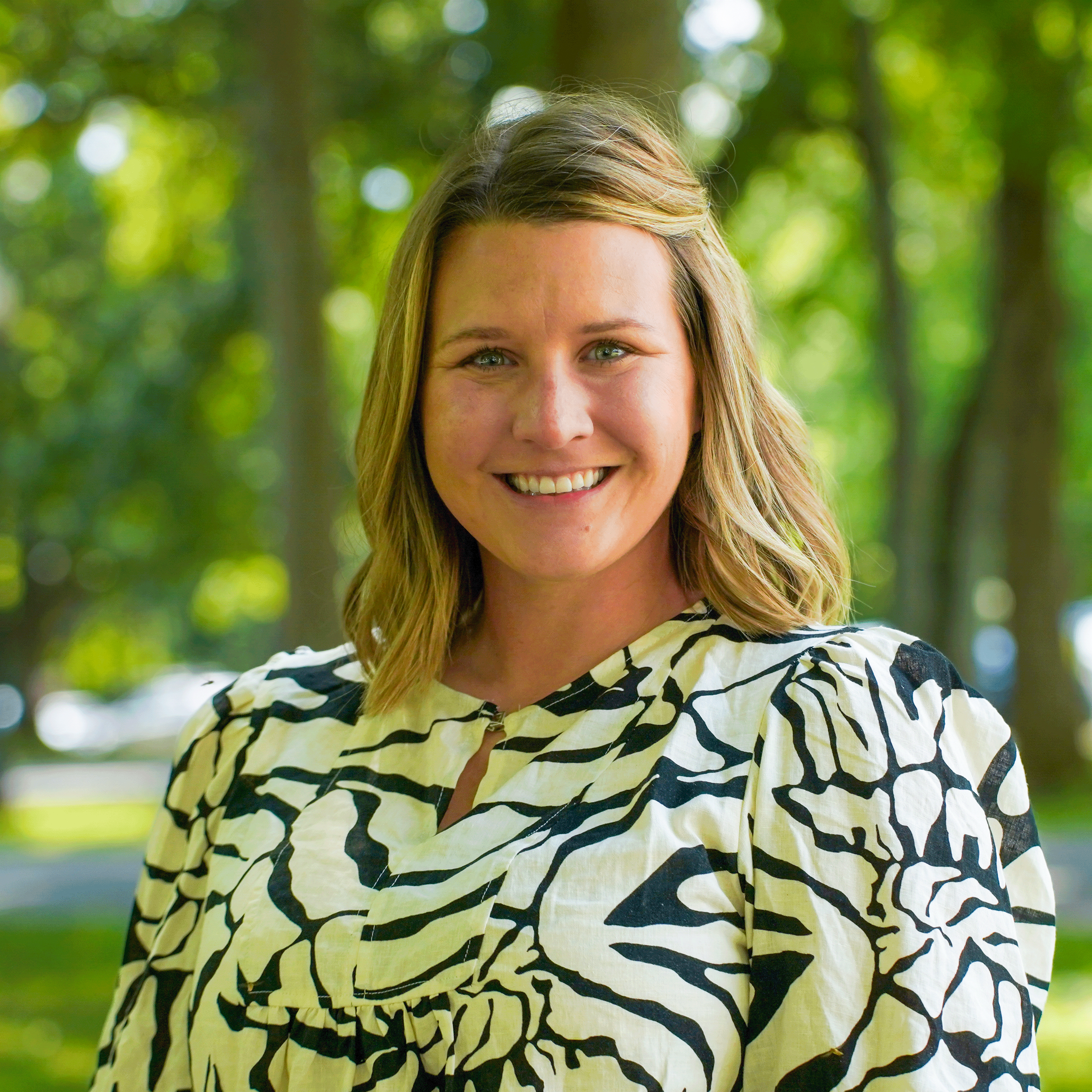 Portrait of Olivia Owens with a green, nature background