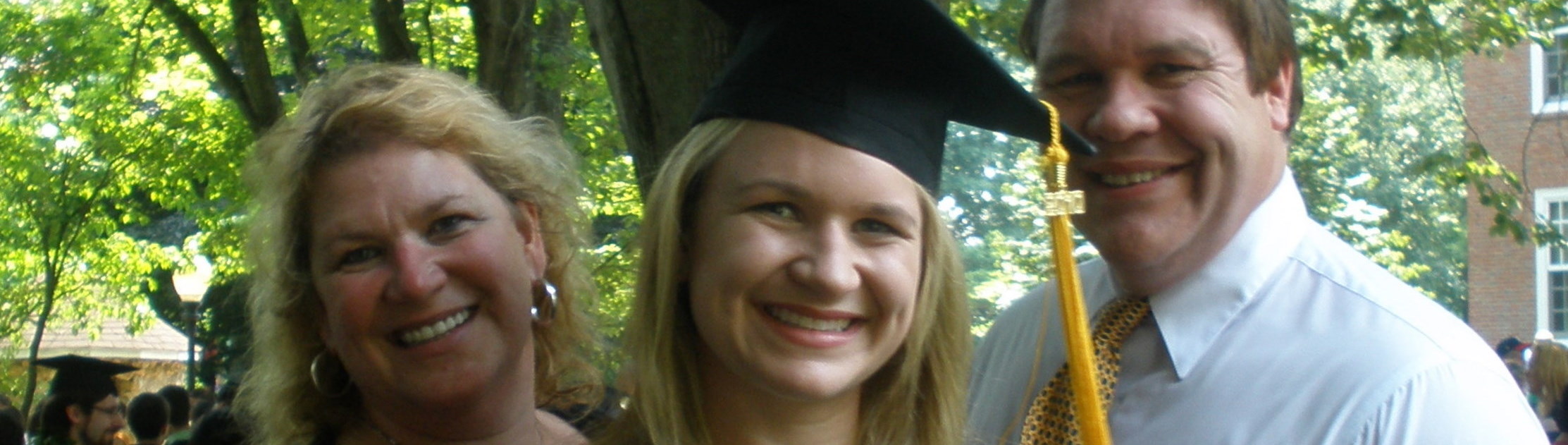 Photo of new graduate with her parents.